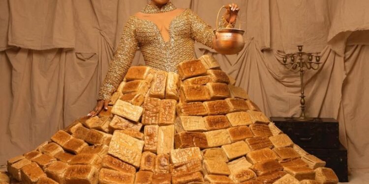 Queen Atang Turns Heads at AMVCA 12 With Bread-Inspired Red Carpet Out fit